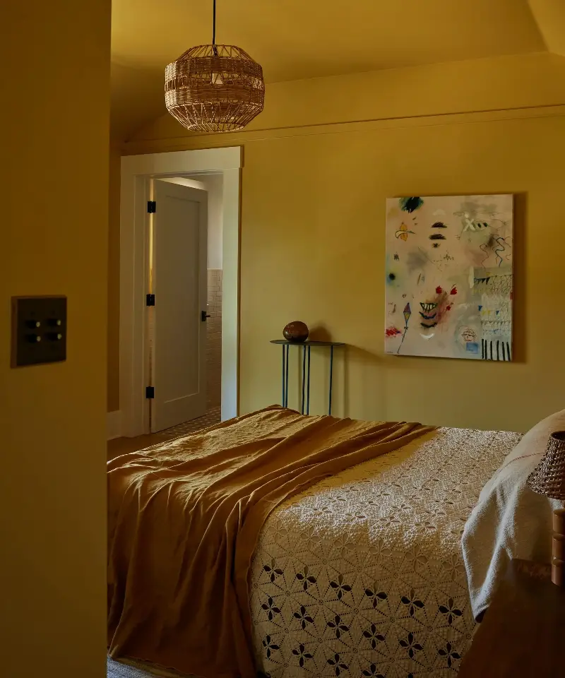 Electric Bowery color-drenches this bedroom in ochre, extending the shade across the walls and ceiling for a warm, cocooning effect that still feels soothing. (Image credit: Electric Bowery)