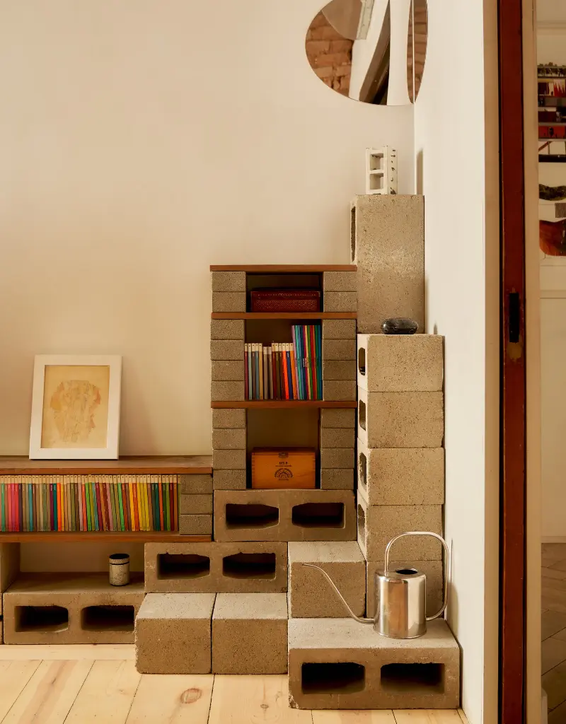 Cedar blocks and wood slabs come together to foster a collection of books and odds in a corner.Seth Caplan. Design: New Operations Workshop. Styling: Logan Sommers