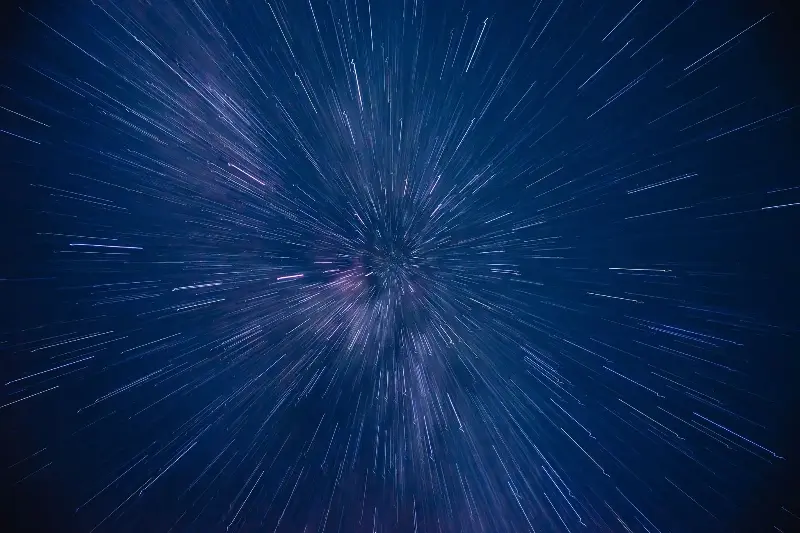 Dynamic star trails creating a dazzling starburst effect in the night sky, captured with long exposure.