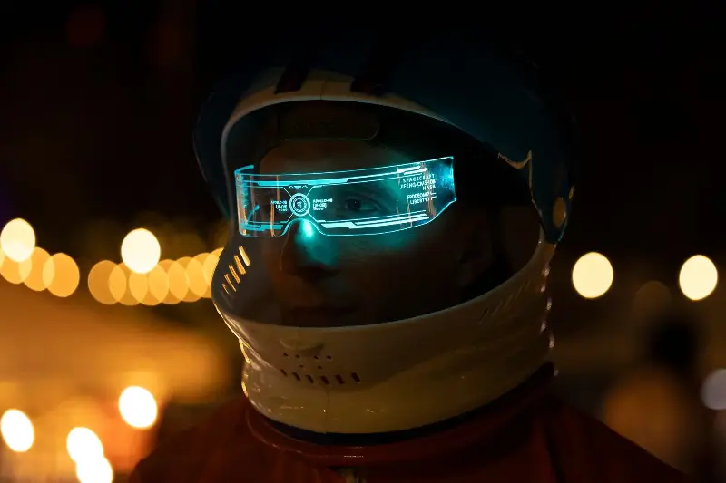 A close-up of a futuristic astronaut helmet featuring a holographic display, creating a sci-fi ambiance.