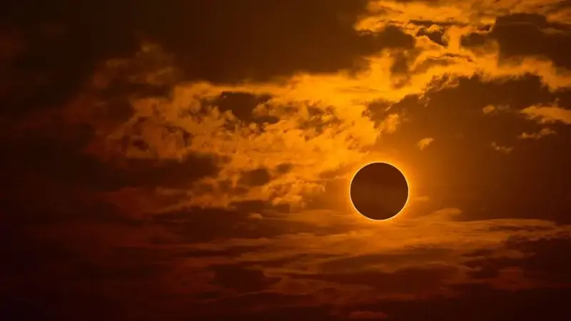 Eclipse on orange sky