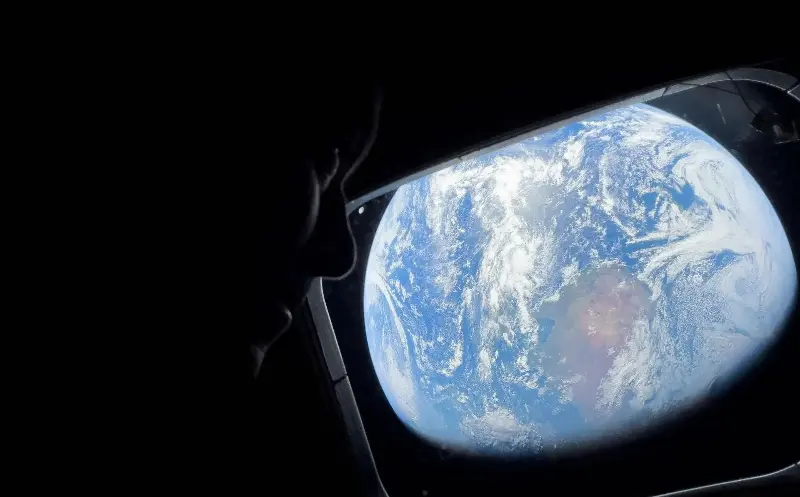 Commander Reid Wiseman looks at Earth from the Orion spacecraft - Nasa via REUTERS