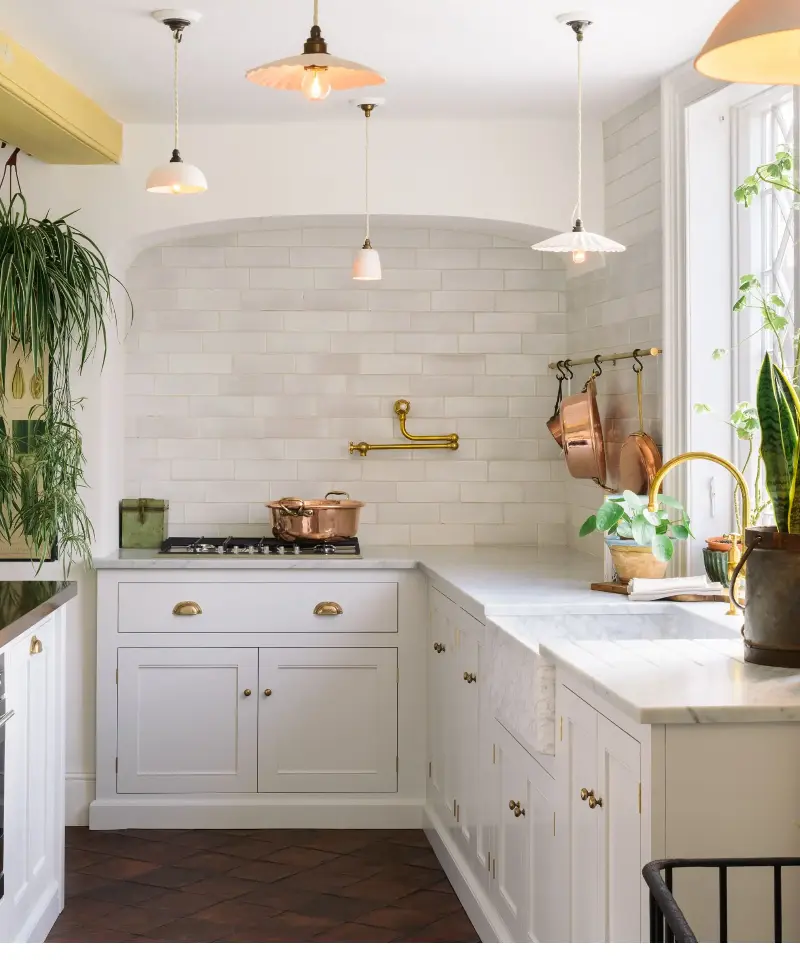 White cabinetry maximizes light while creating a neutral foundation that can evolve with changing tastes. (Image credit: deVOL)