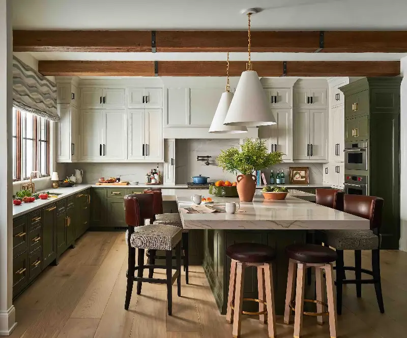 Deep olive green cabinetry creates a sophisticated contrast against white uppers, keeping the kitchen bright yet grounded. (Image credit: Stephen Karlisch/Amanda Lantz Interiors)