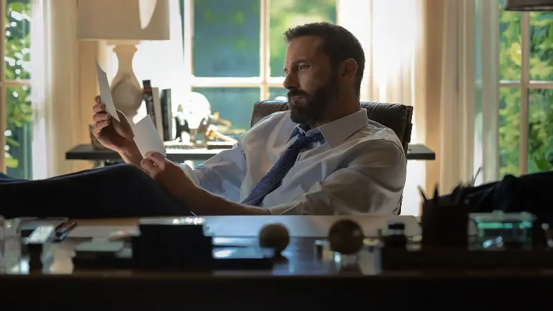 Ben Affleck sitting by his desk in Animals