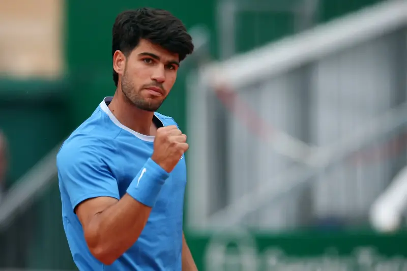 Spain's Carlos Alcaraz reacts after a point against Italy's Jannik Sinner during the Monte Carlo ATP Masters Series Tournament final tennis match on Court Rainier III at the Monte-Carlo Country Club in Roquebrune-Cap-Martin, south-eastern France on April 12, 2026. (Photo by Valery HACHE / AFP via Getty Images)