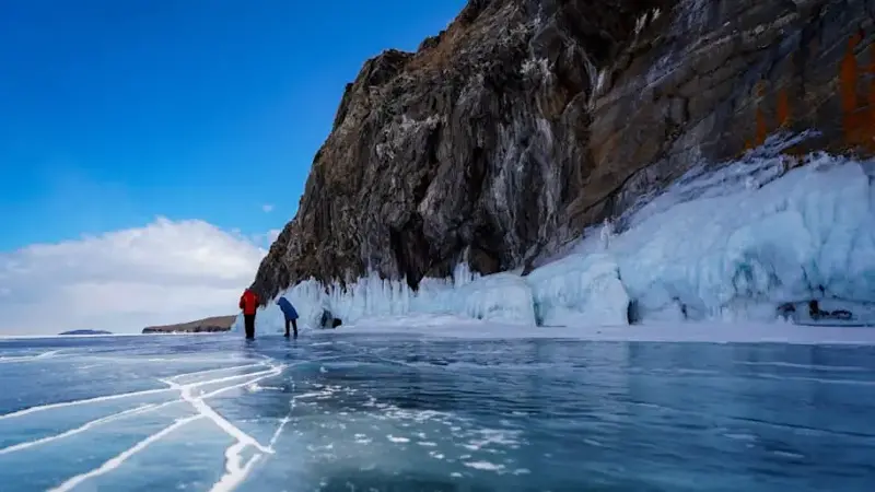 People walk on the frozen Lake Baikal in Russia
