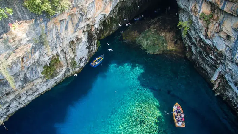 Boats float in Greece's Melissani Lake